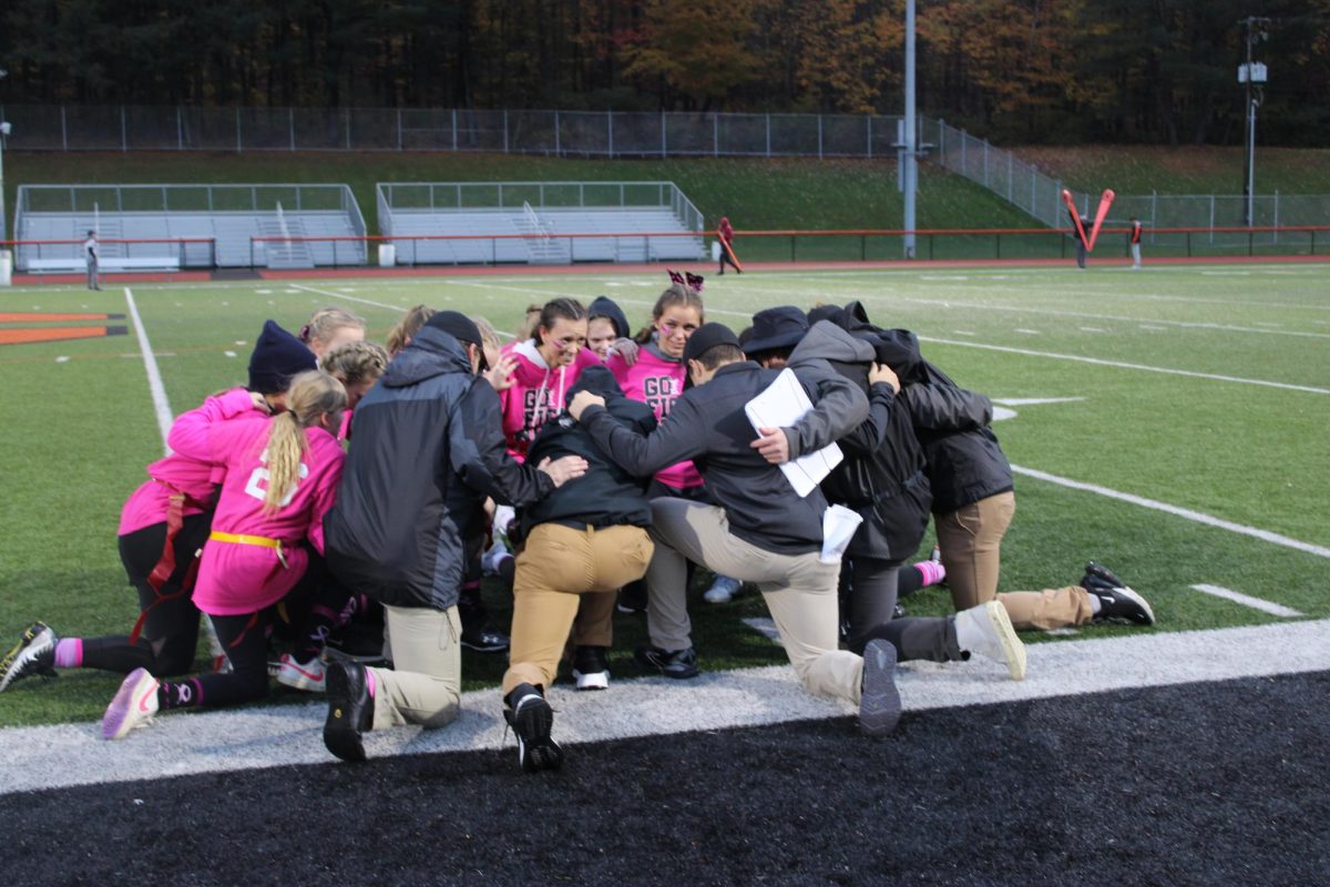 Football players and cheerleaders swap roles for Powder Puff game