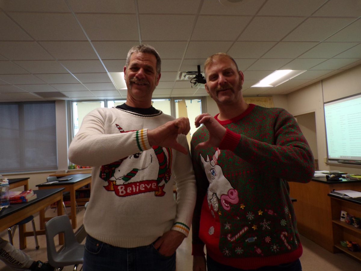 Mr. Brady and Mr. Brumagin showing off their ugly sweaters
