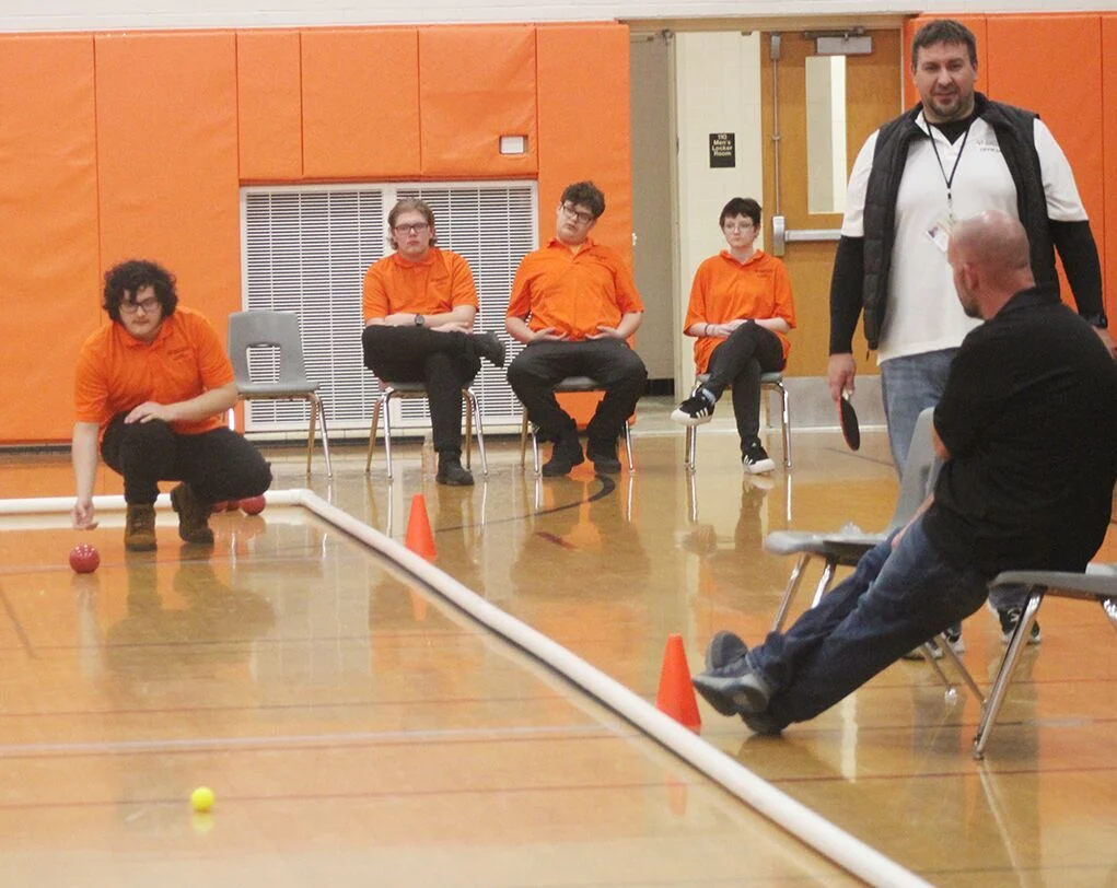 Players Dominic Sanchez, Dustin Rose, Garrett Light, and McKenna Music compete while Head Coach Mr. Chud looks on