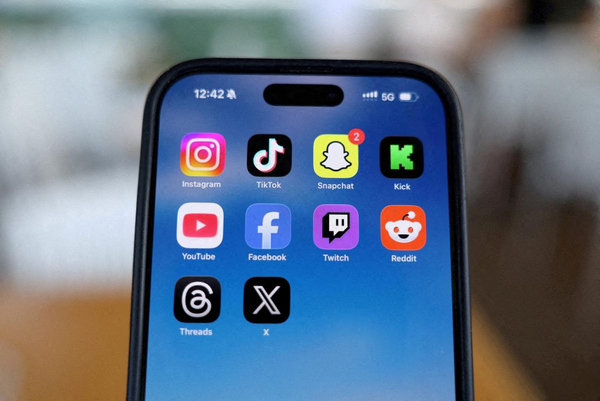 Instagram, TikTok, Snapchat, Kick, YouTube, Facebook, Twitch, Reddit, Threads and X applications are displayed on a mobile phone, in this picture illustration taken on December 9, 2025. REUTERS/Hollie Adams/Illustration