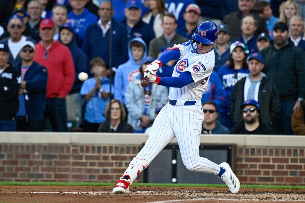 Oct 8, 2025; Chicago, Illinois, USA; Chicago Cubs center fielder Pete Crow-Armstrong (4) hits a two-run single against the Milwaukee Brewers in the first inning during game three of the NLDS round for the 2025 MLB playoffs at Wrigley Field. Mandatory Credit: Matt Marton-Imagn Images
